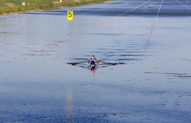 Image showing Two man in a sports boat rowing on the lake