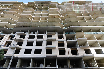 Image showing High-rise construction of a new building, decoration of the facades of the first floors