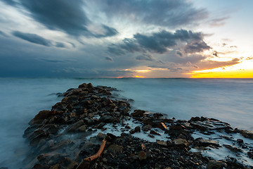 Image showing Sea sunset after sunset, in the foreground a breakwater of stones