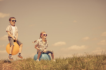 Image showing Brother and sister playing on the field