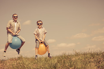 Image showing Father and son playing on the field