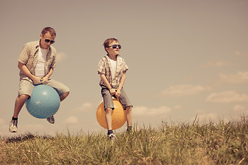 Image showing Father and son playing on the field