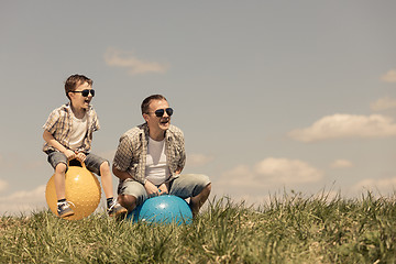 Image showing Father and son playing on the field 