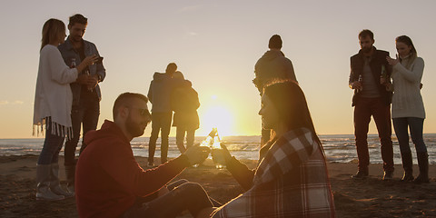 Image showing Friends having fun at beach on autumn day