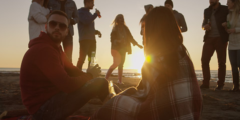 Image showing Friends having fun at beach on autumn day