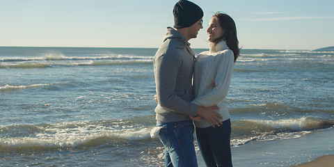 Image showing Couple having fun on beautiful autumn day at beach