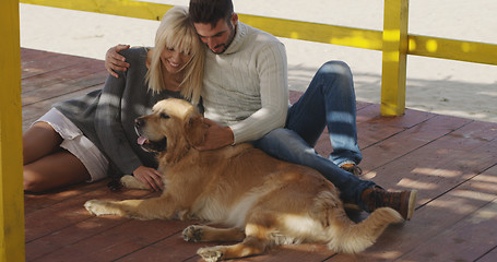 Image showing Couple with dog enjoying time on beach