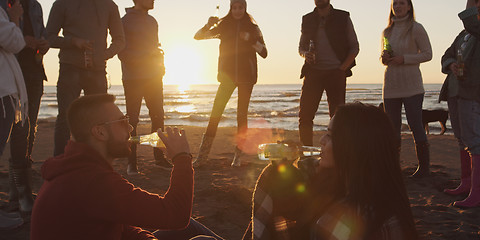 Image showing Friends having fun at beach on autumn day