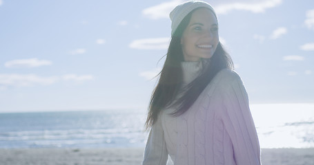 Image showing Girl In Autumn Clothes Smiling on beach