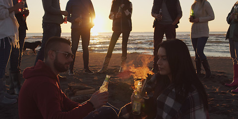 Image showing Friends having fun at beach on autumn day