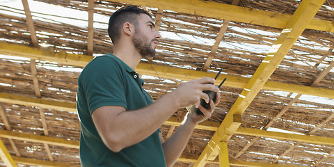 Image showing Man Operating Drone By The Sea