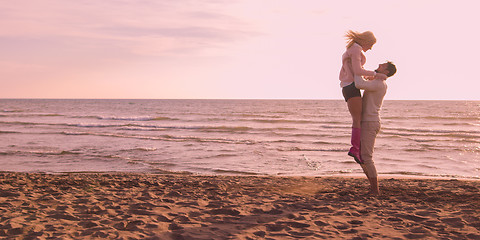 Image showing Loving young couple on a beach at autumn on sunny day