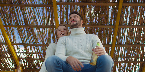 Image showing Couple drinking beer together at the beach