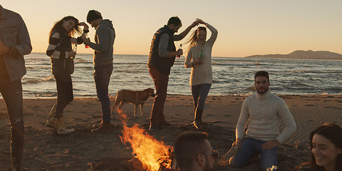 Image showing Friends having fun at beach on autumn day