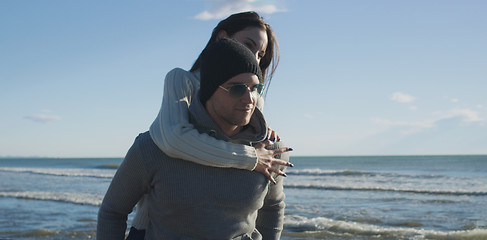 Image showing couple having fun at beach during autumn