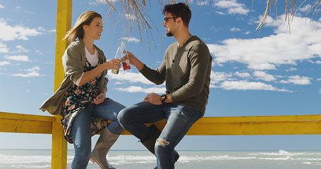 Image showing Group of friends having fun on autumn day at beach