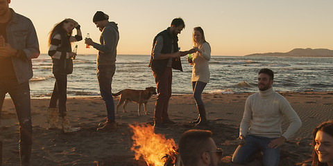 Image showing Friends having fun at beach on autumn day