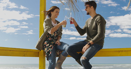 Image showing Group of friends having fun on autumn day at beach