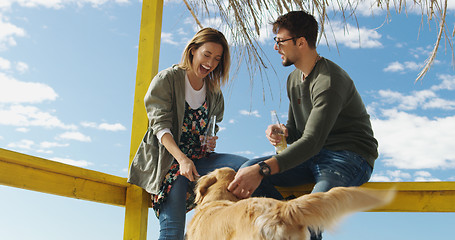 Image showing Group of friends having fun on autumn day at beach