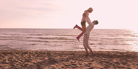 Image showing Loving young couple on a beach at autumn on sunny day