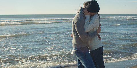 Image showing Couple having fun on beautiful autumn day at beach