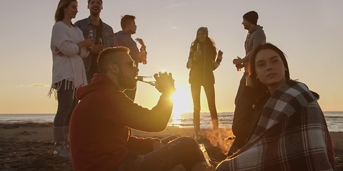 Image showing Friends having fun at beach on autumn day