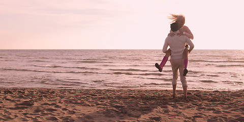 Image showing Loving young couple on a beach at autumn on sunny day