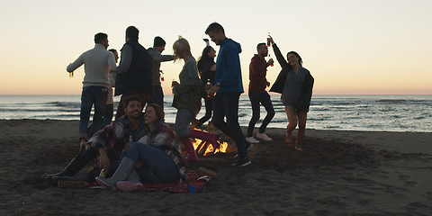 Image showing Friends having fun at beach on autumn day