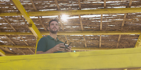 Image showing Man Operating Drone By The Sea