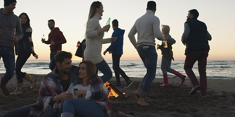 Image showing Friends having fun at beach on autumn day