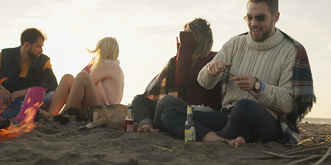 Image showing Friends Relaxing At Bonfire Beach Party
