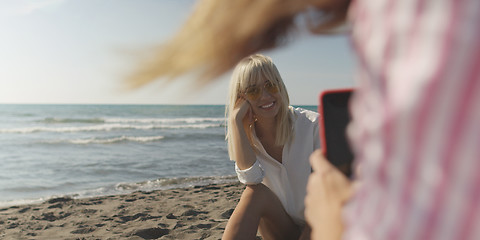 Image showing Two girl friends having fun photographing each other on vecation