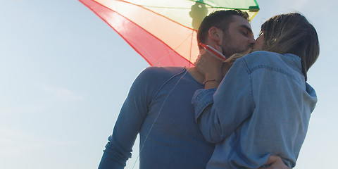 Image showing Happy couple having fun with kite on beach