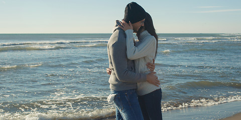 Image showing Couple having fun on beautiful autumn day at beach