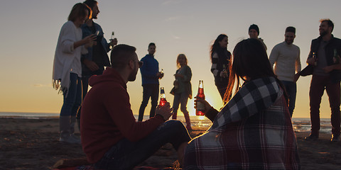 Image showing Friends having fun at beach on autumn day