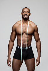 Image showing Fit young man with beautiful torso isolated on gray background