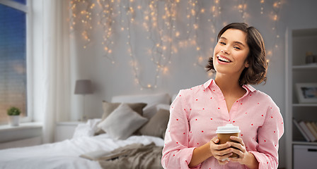 Image showing happy young woman in pajama with cup of coffee