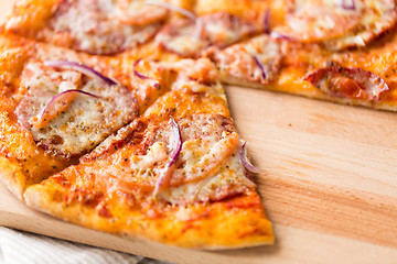 Image showing close up of homemade pizza on wooden table