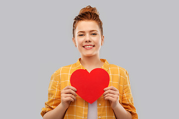 Image showing smiling red haired teenage girl with heart