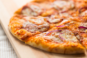 Image showing close up of homemade pizza on wooden table