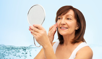 Image showing portrait of smiling senior woman with mirror