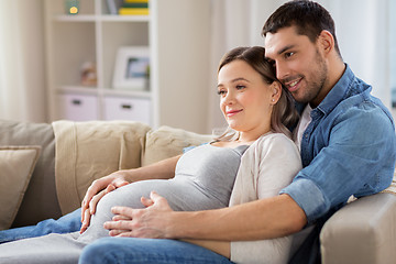 Image showing man hugging pregnant woman at home