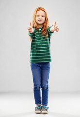 Image showing smiling red haired girl showing thumbs up