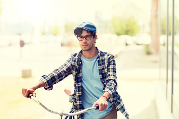 Image showing young man with fixed gear bicycle walking in city