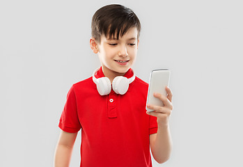 Image showing boy in red t-shirt with headphones and smartphone