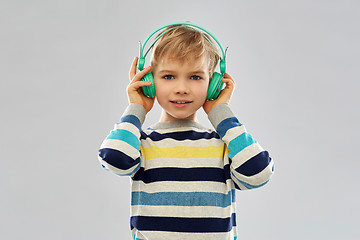 Image showing smiling boy in headphones listening to music