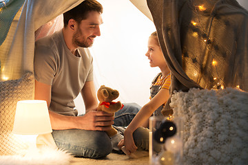 Image showing happy family playing with toy in kids tent at home