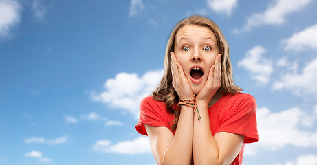 Image showing shocked or scared teenage girl over sky