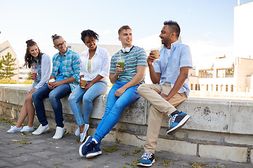 Image showing friends drinking coffee and juice talking in city