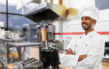 Image showing happy male indian chef in toque at kebab shop